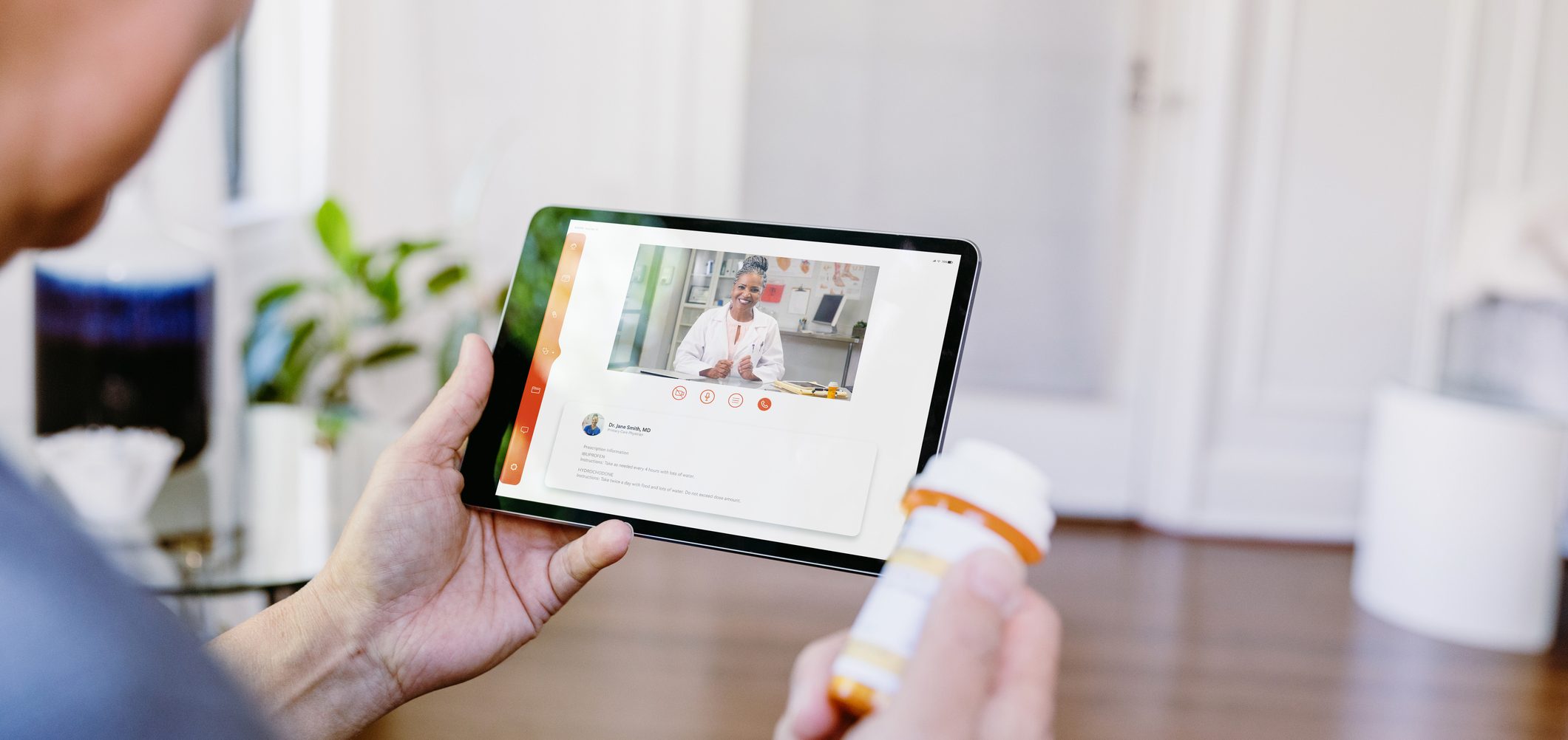 While holding a prescription medication container, an unrecognizable senior man video chats with a female doctor. The man is asking questions about his medication.